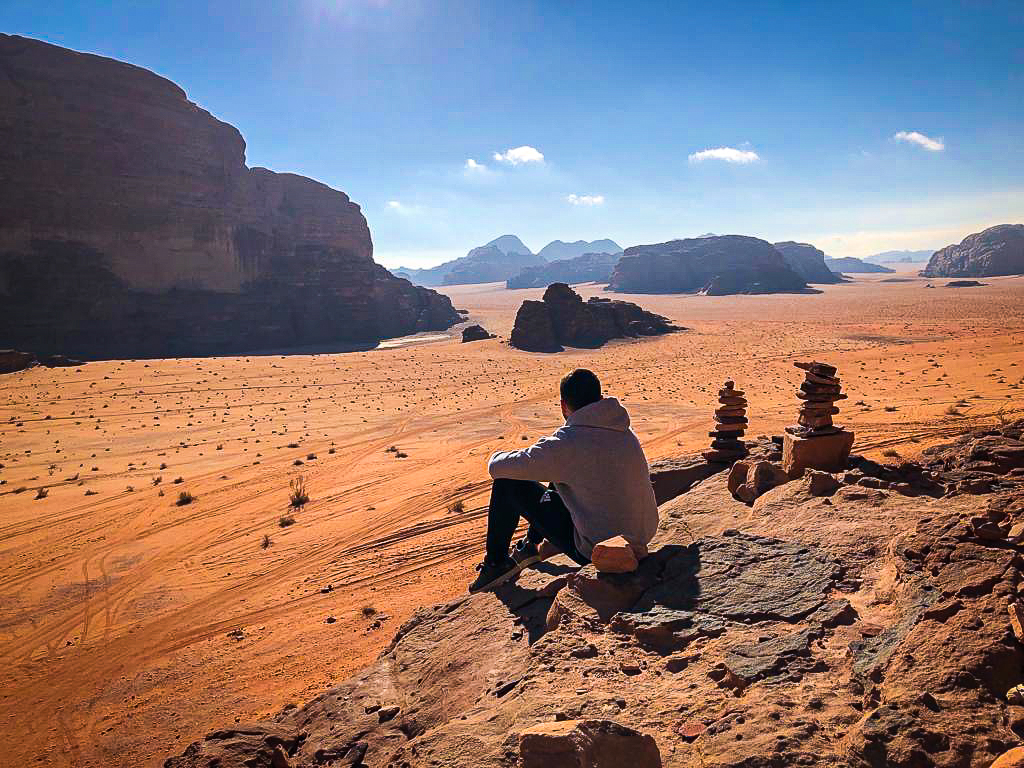 Man sitting in the Wadi Rum Desert in Jordan