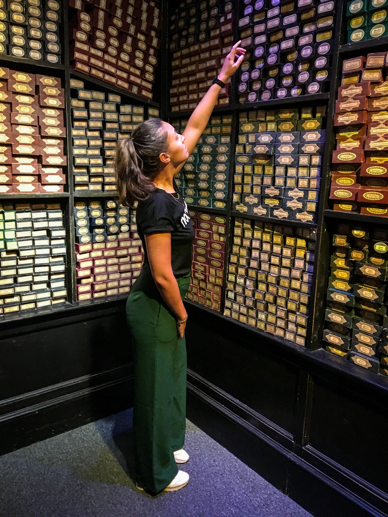 Woman choosing her wand at Ollivander's shop in the Warner Bros Studios in London