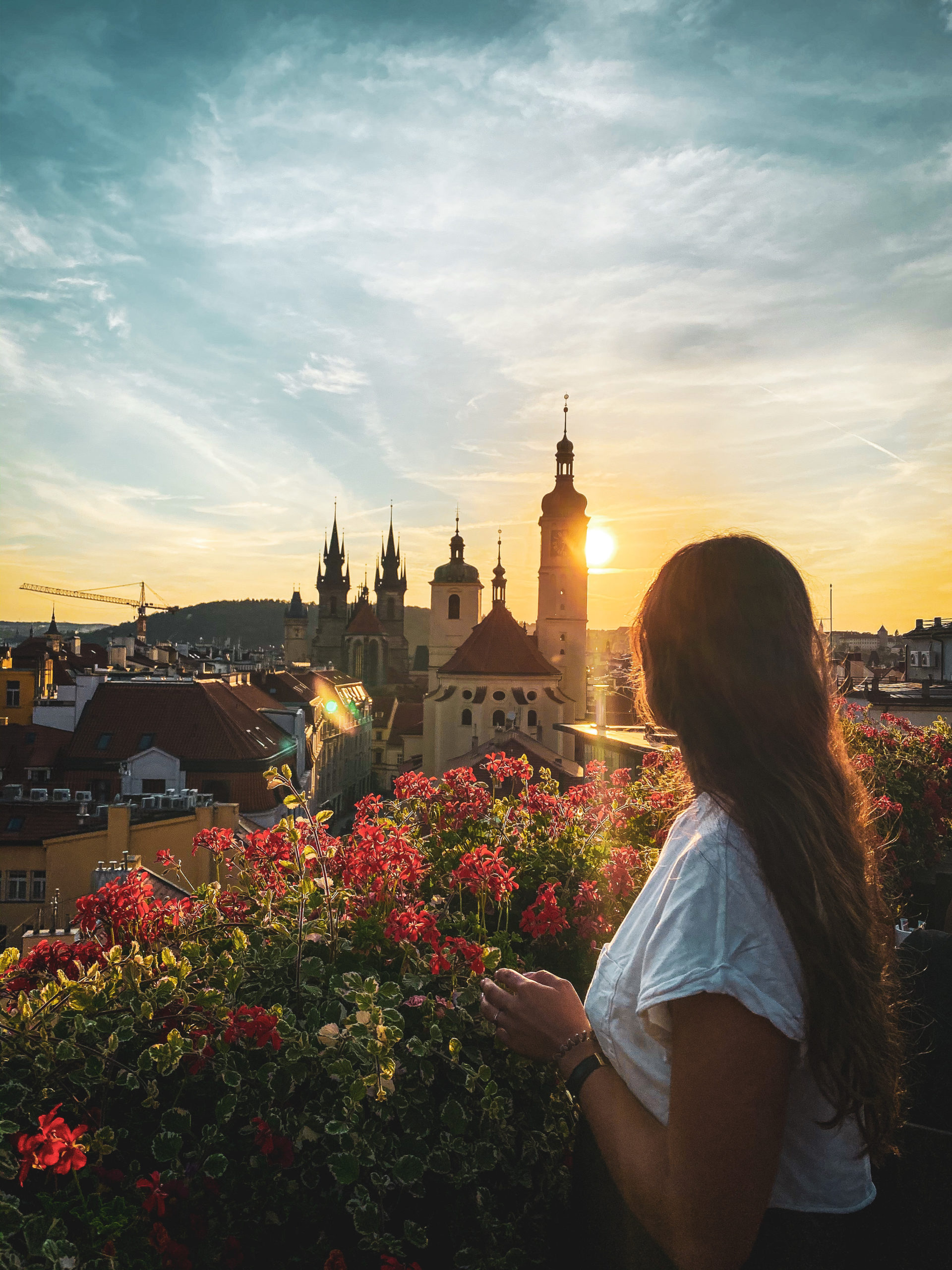 Woman observing the sunset over Prague