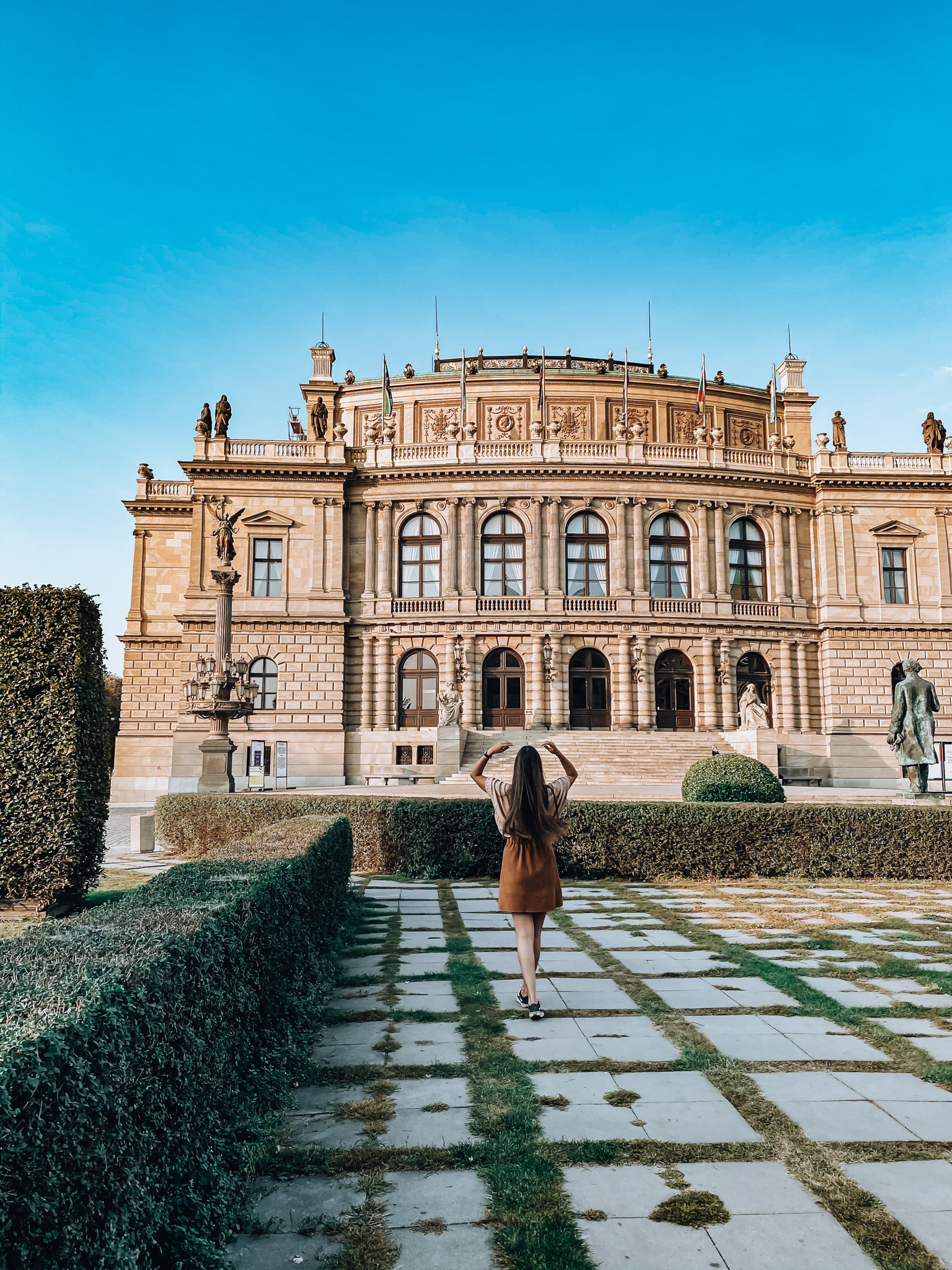 Woman standing in front of an opera house in Prague 