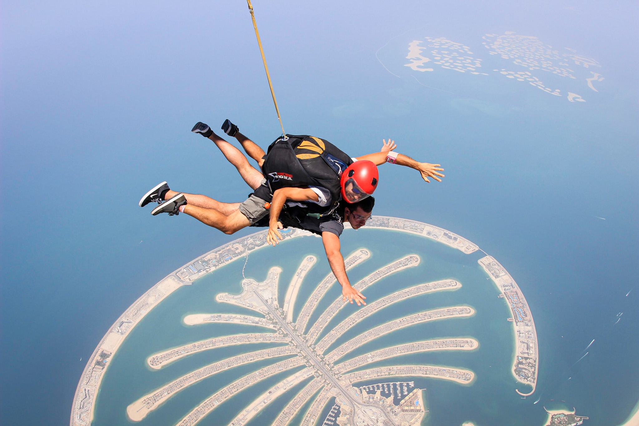 Man skydiving in Dubai above the Palms and the World islands
