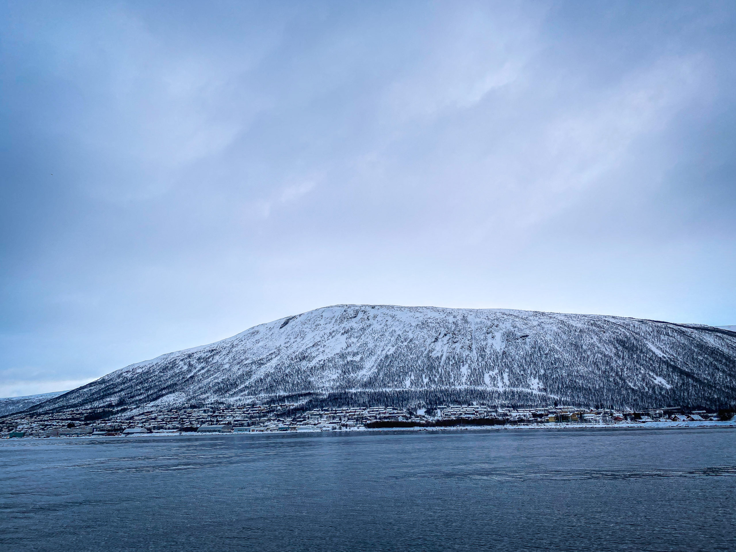 Snowy island on the sea in Tromsø