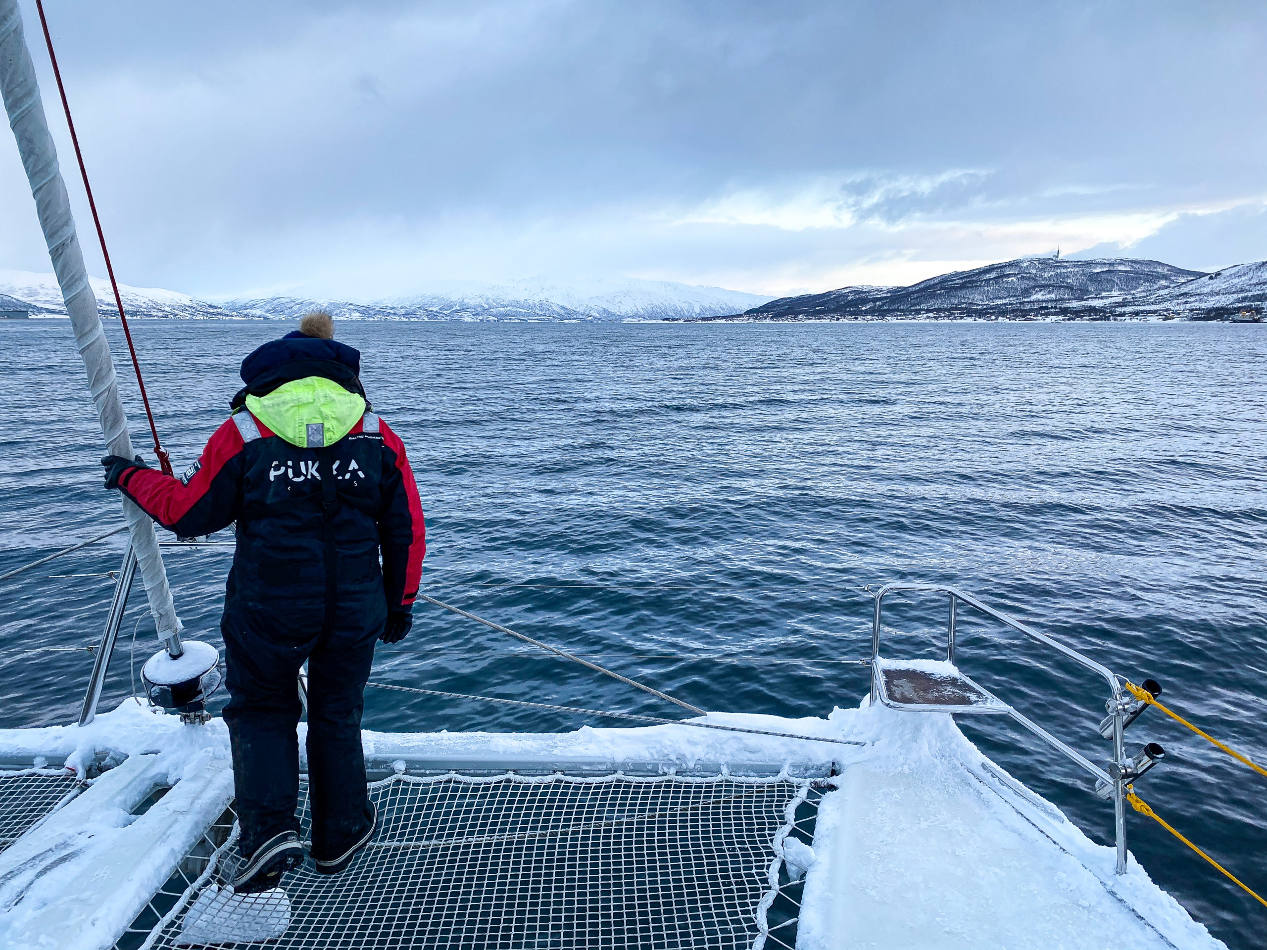 Man standing on a boat in Tromsø