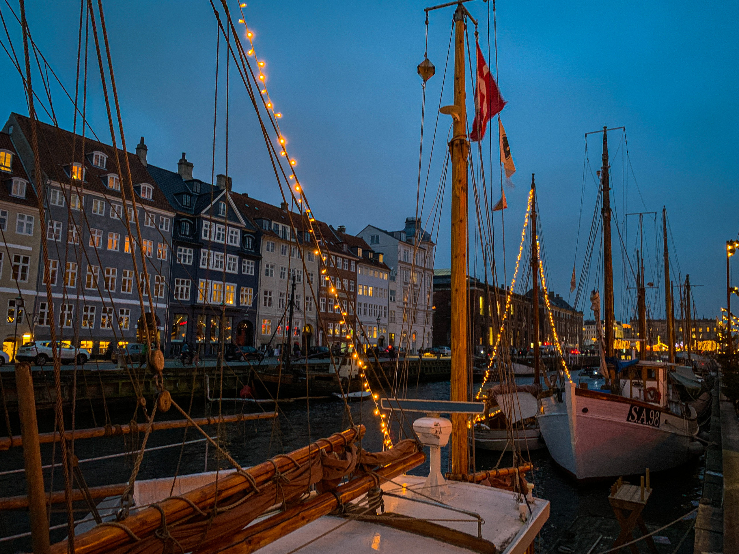Nyhavn by night with houses and boats in Copenhagen