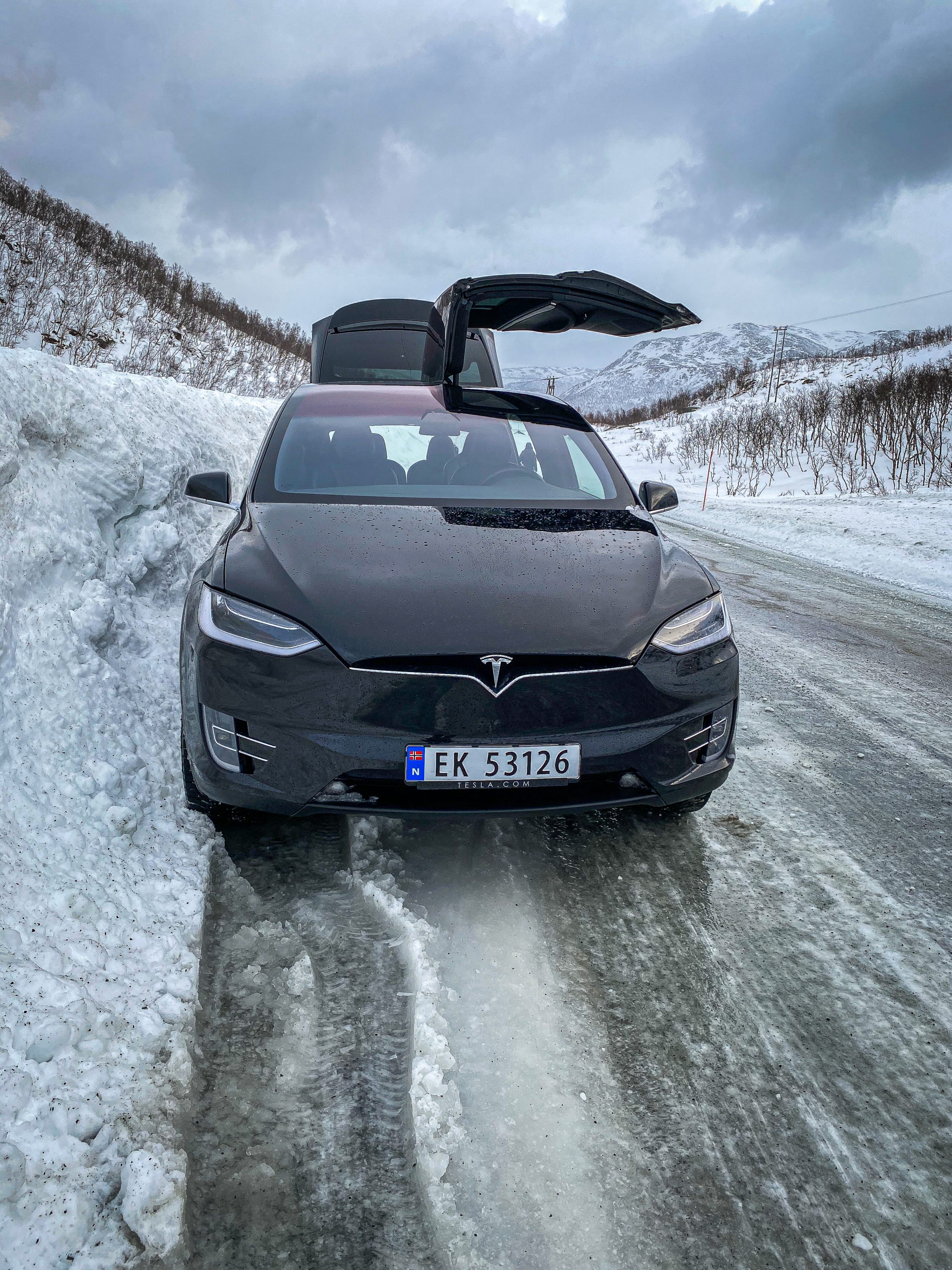 Tesla Model X in the snow with a door open in Tromsø