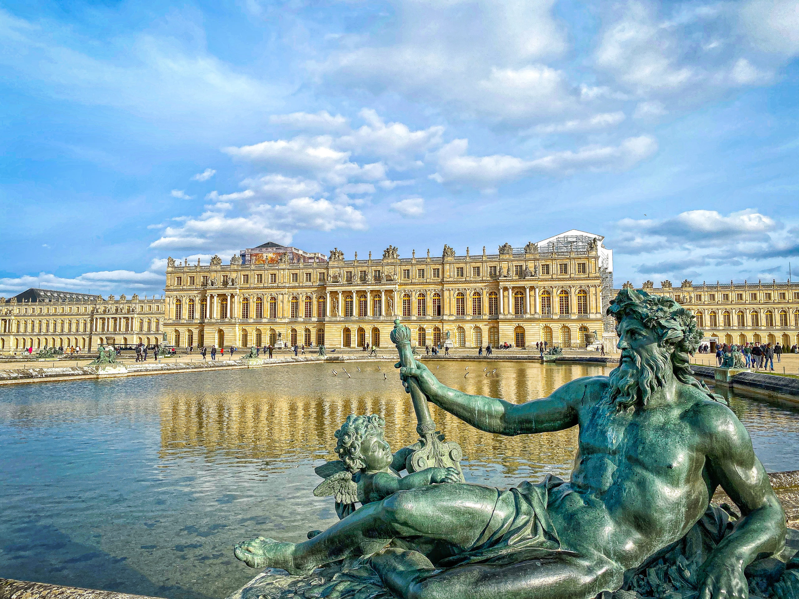 View of Versailles palace and a state of Poseidon in Paris