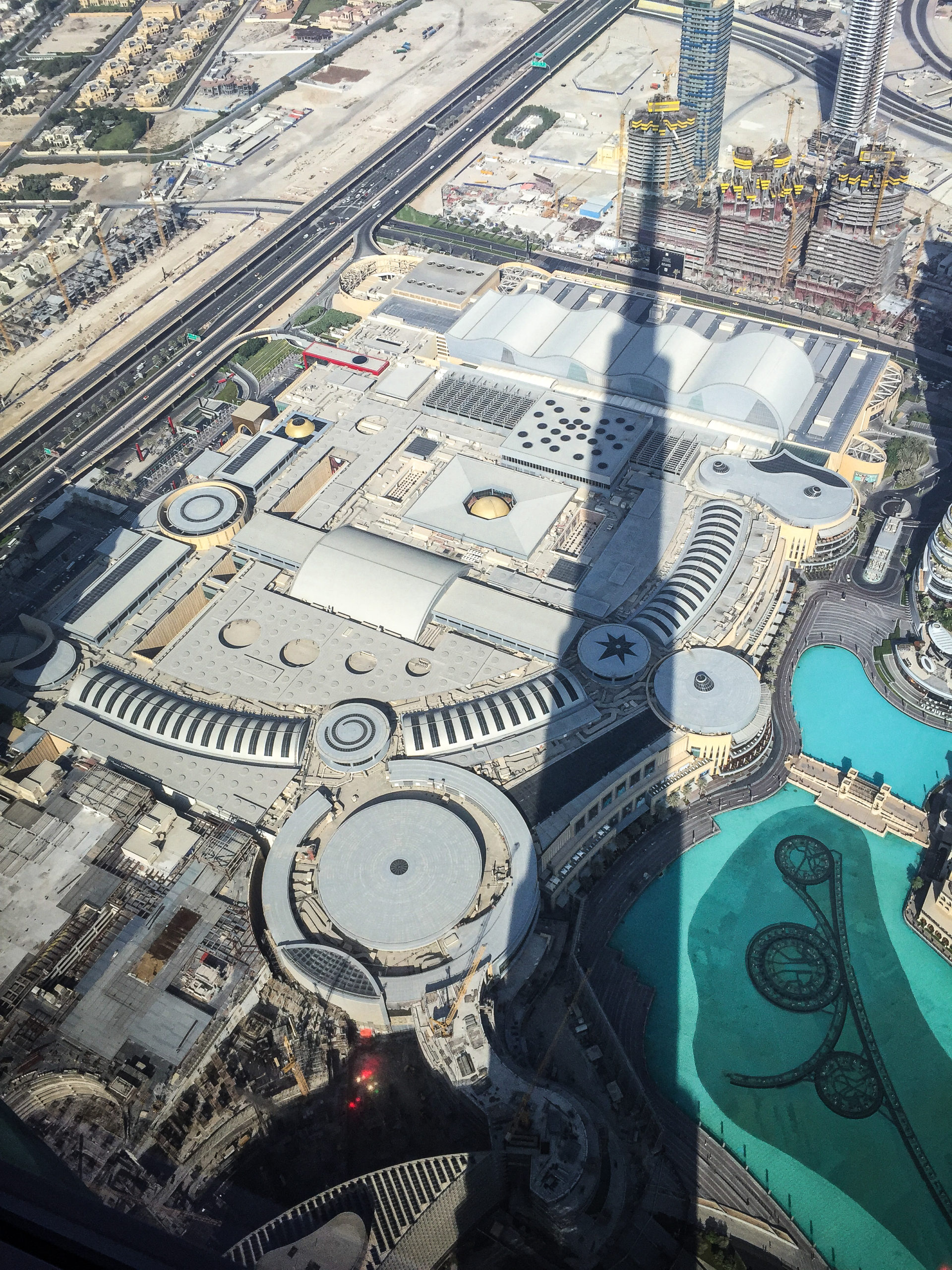 View over Dubai from the top of the Burj Khalifa with its shadow in Dubai