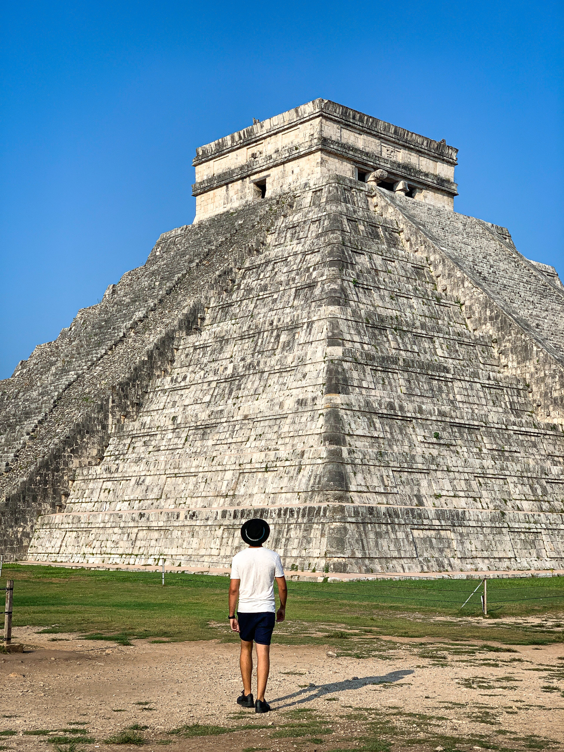 IMG_6043 Chichen itza with a man standing in front of it in Mexico