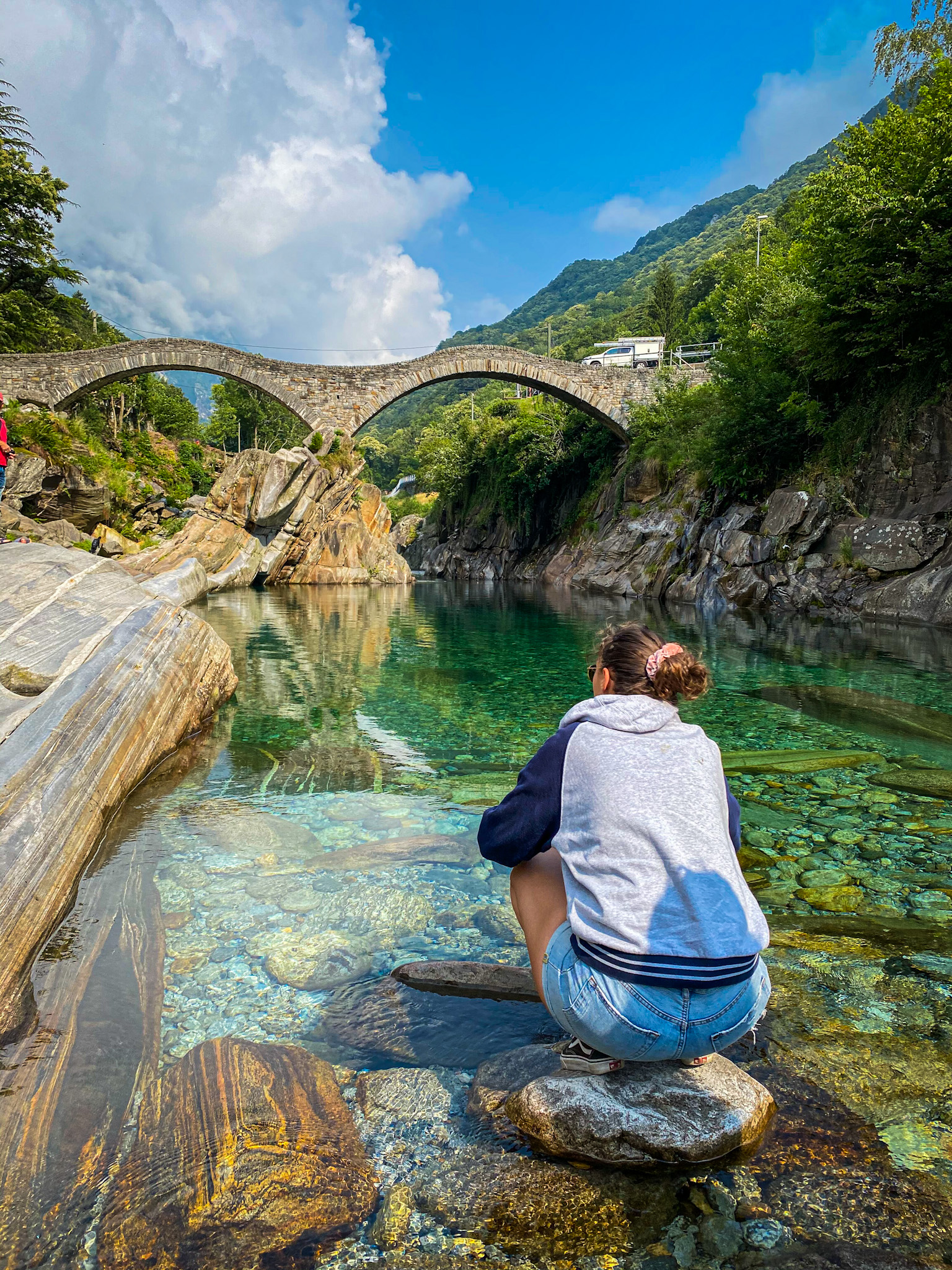 Woman in front of the bridge in Valle Verzasca in Switzerland