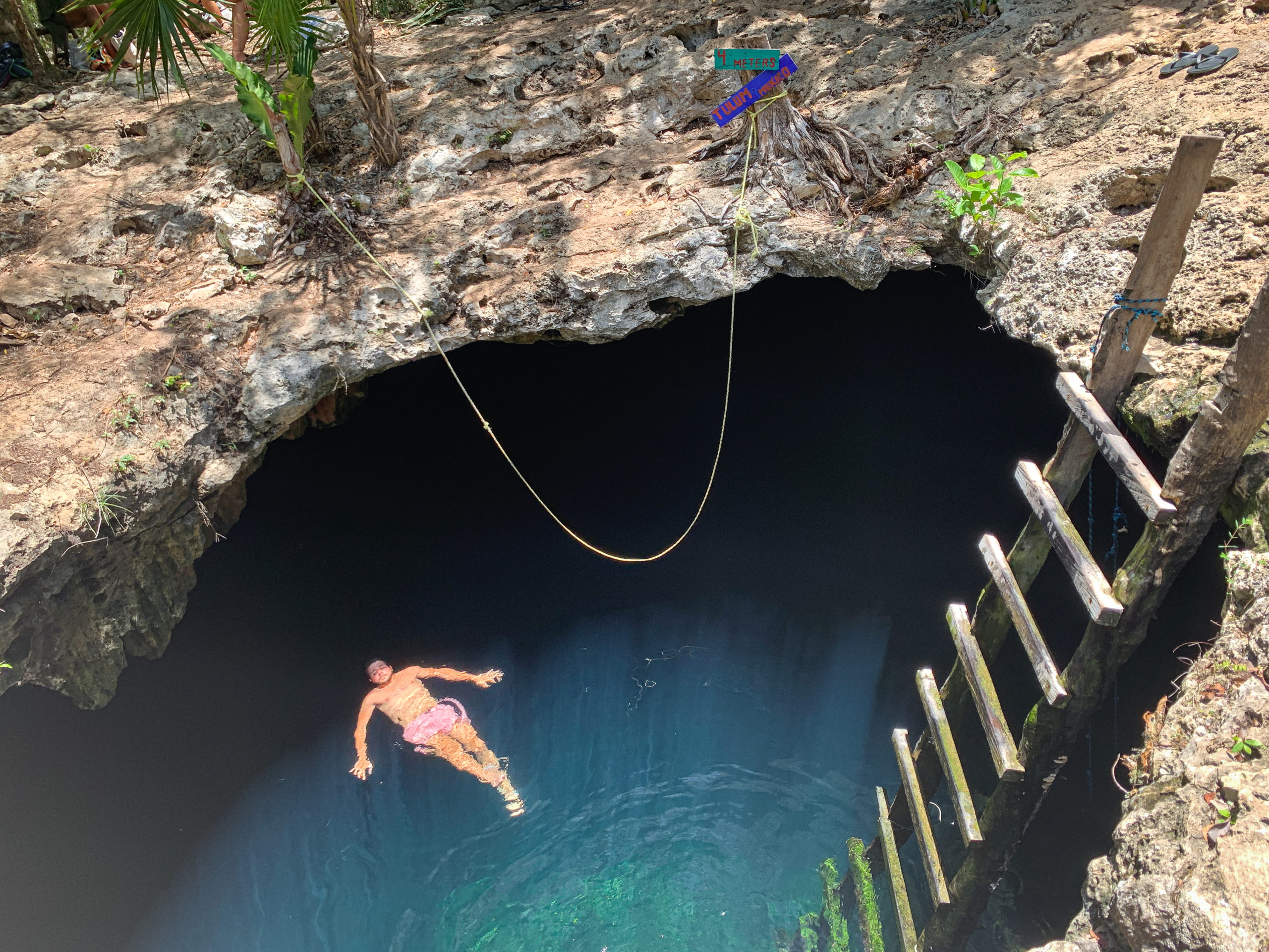 IMG_6214 Man lying on his back in Cenote Calavera near Tulum