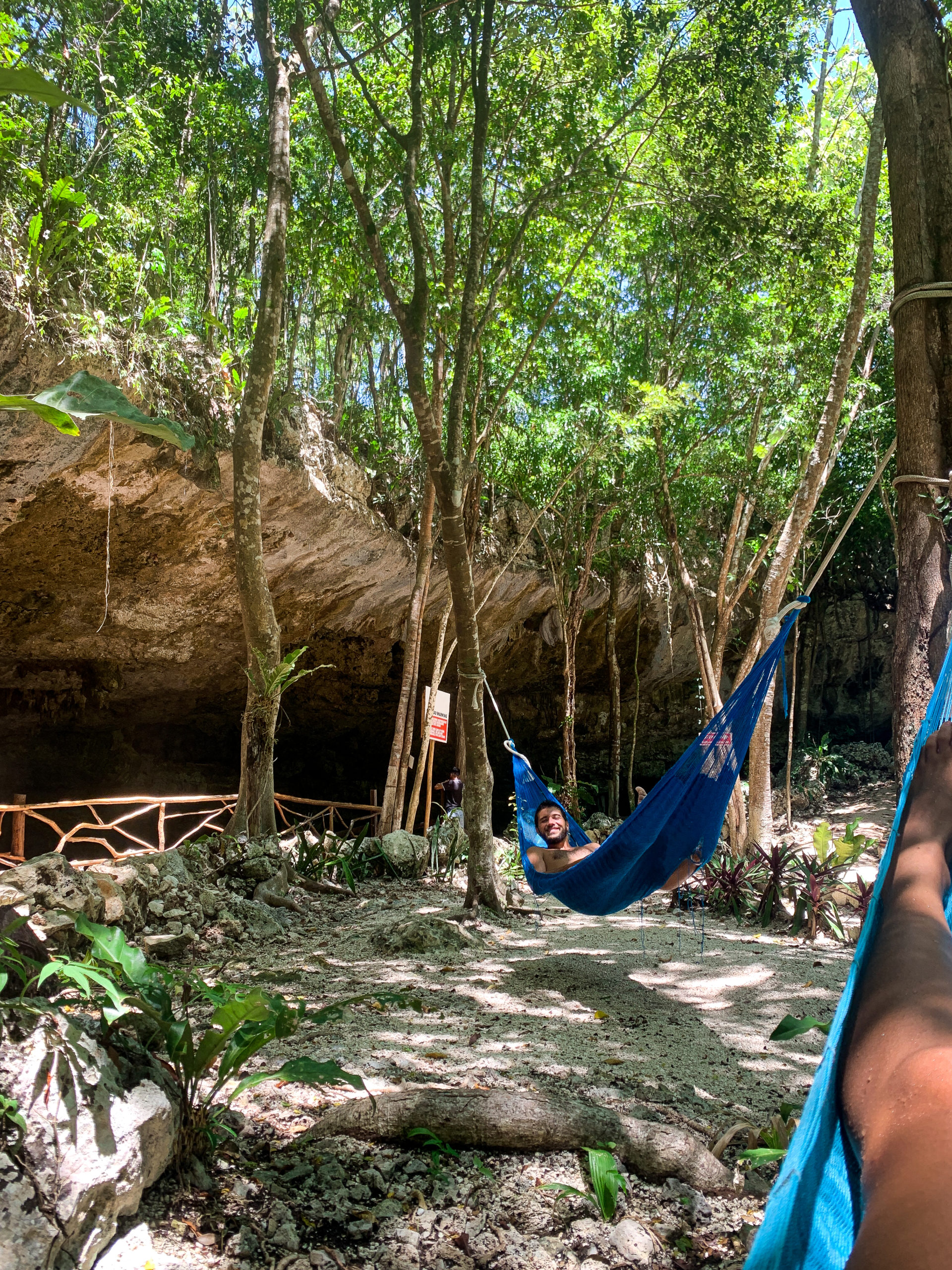 People lying in a hammock in Cenote Dos Ojos near Tulum