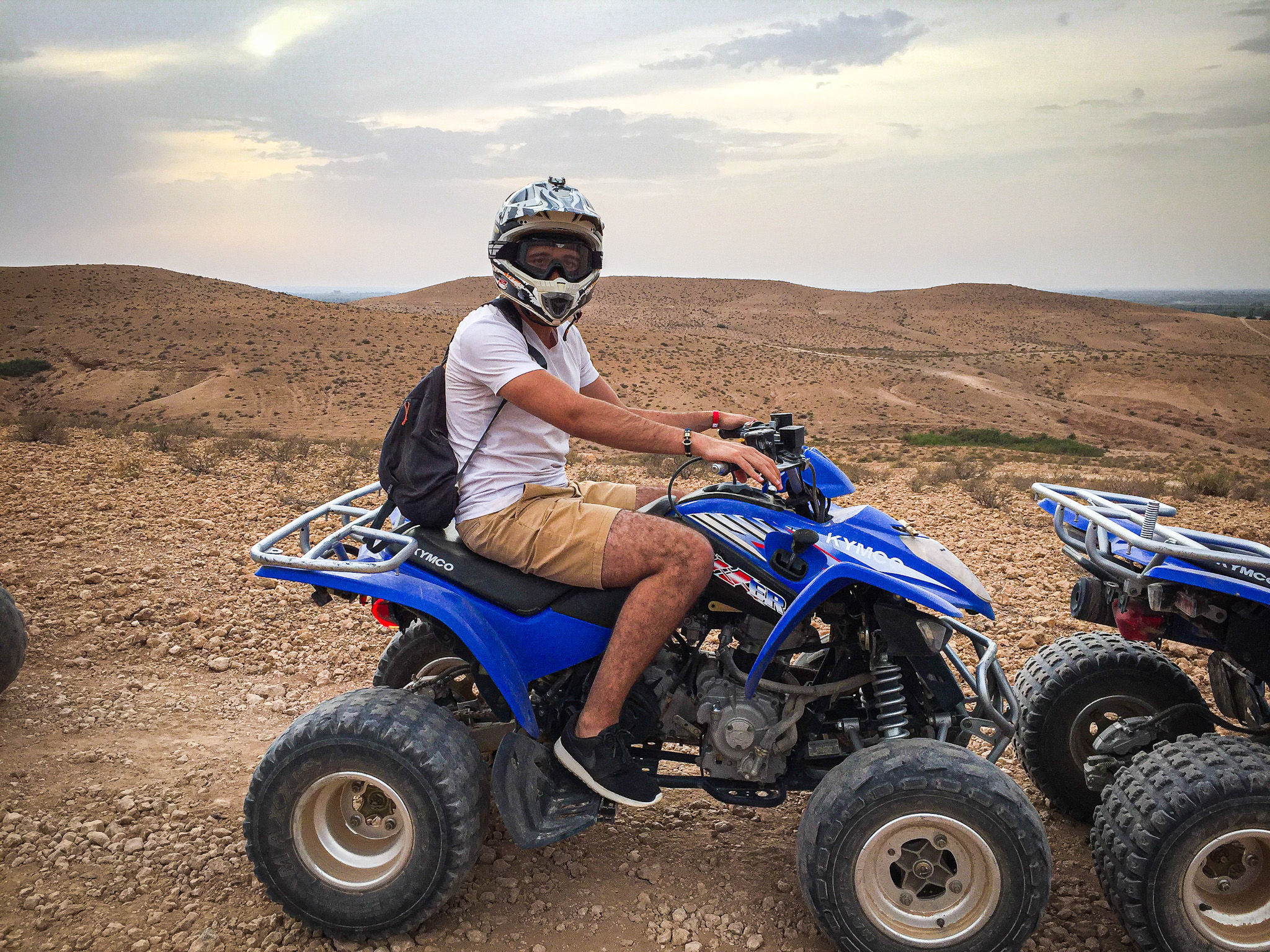 Man sitting on a quad in Dubai desert