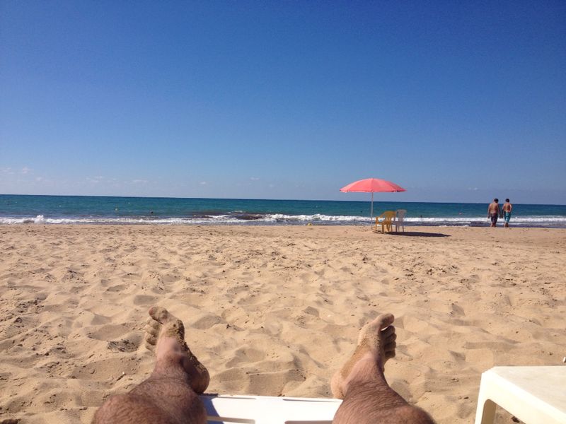 Man's legs on the beach in Rmeileh in Lebanon