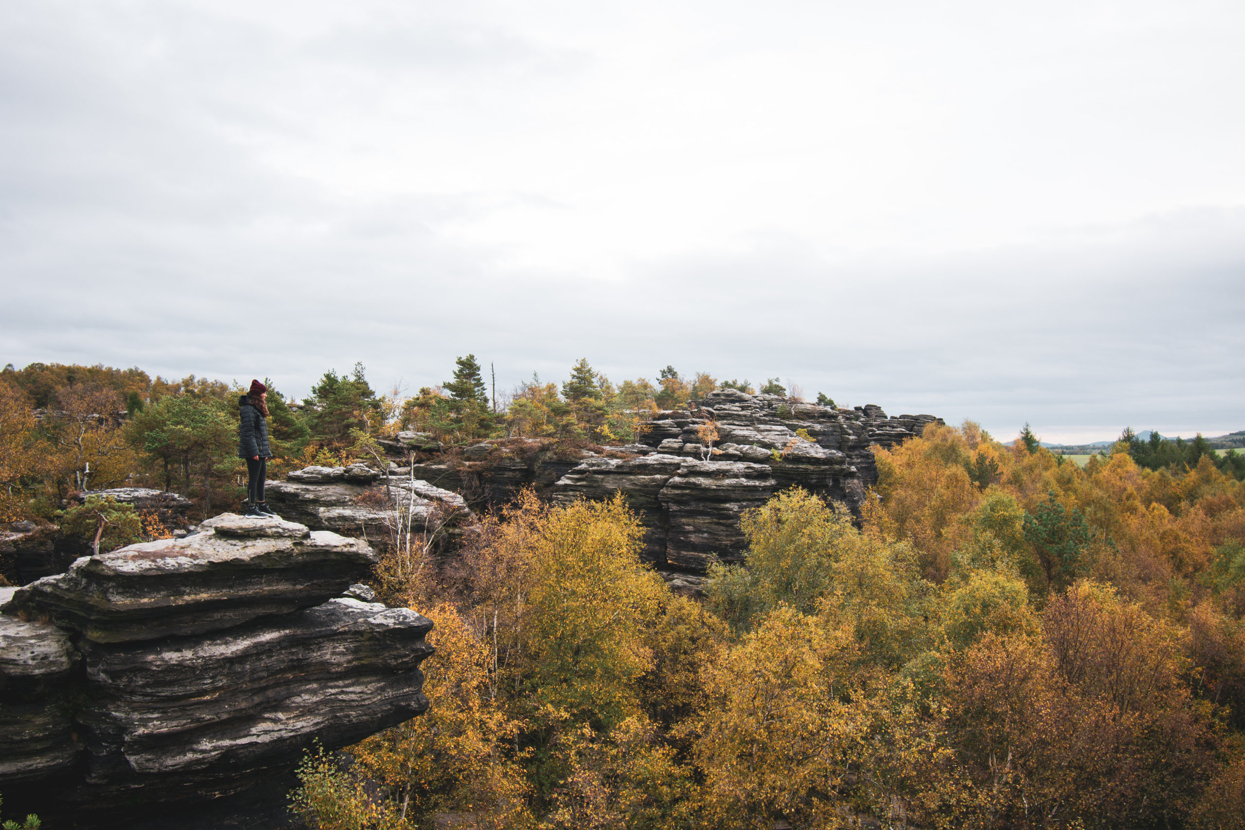 Woman standing in a rock formation in Bohemian Switzerland National park in Czech Republic