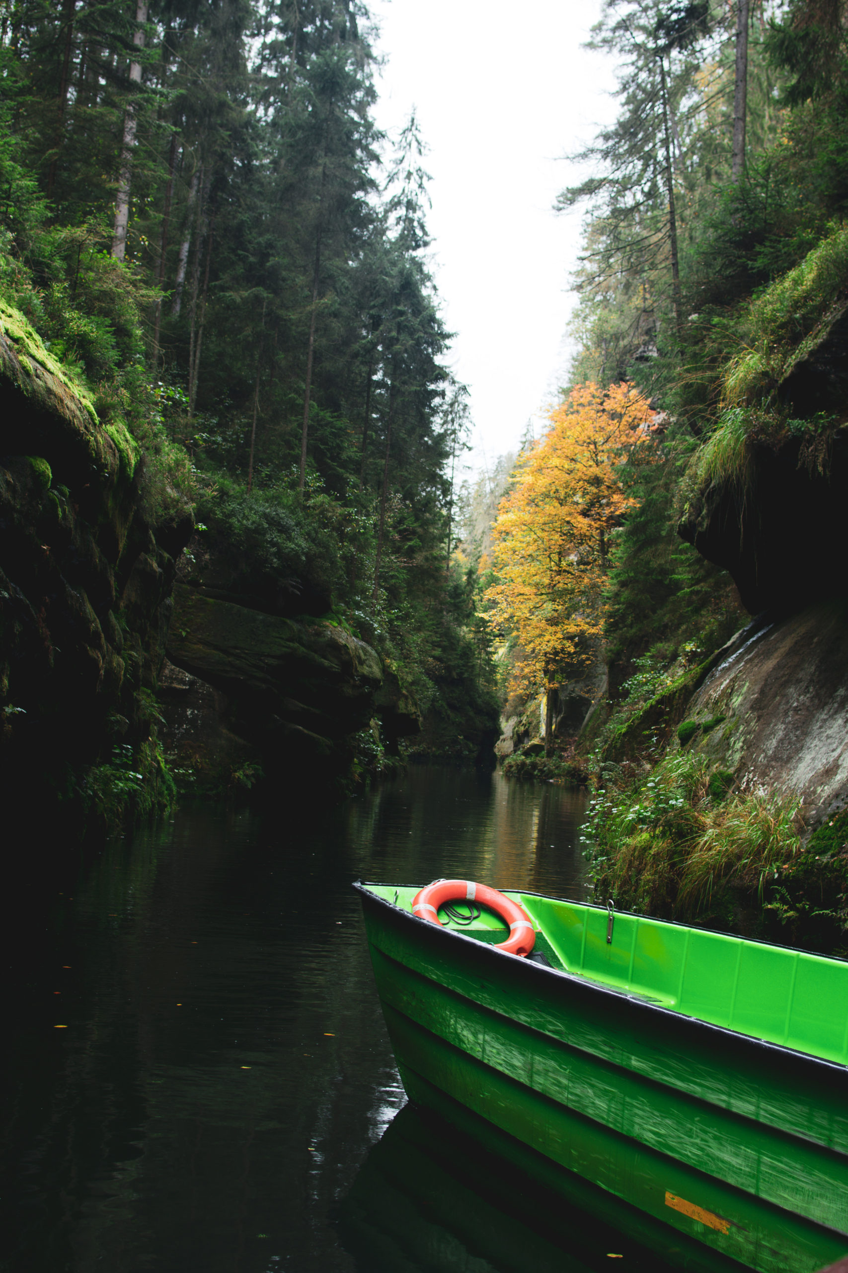 Green boat in Edmundsklamm in Bohemian Switzerland National Park in Czech Republic