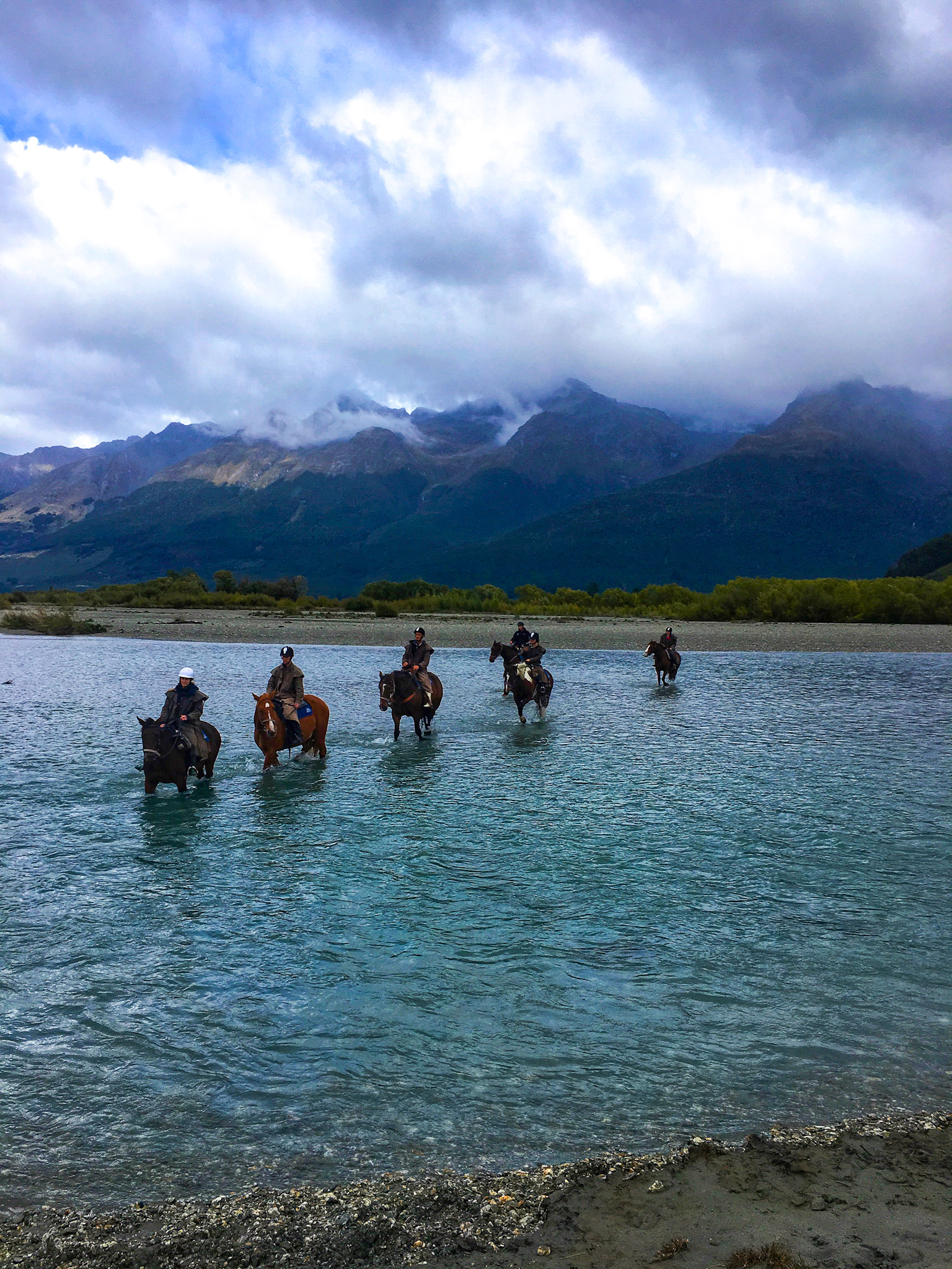 Horseback riding in a river in New Zealand