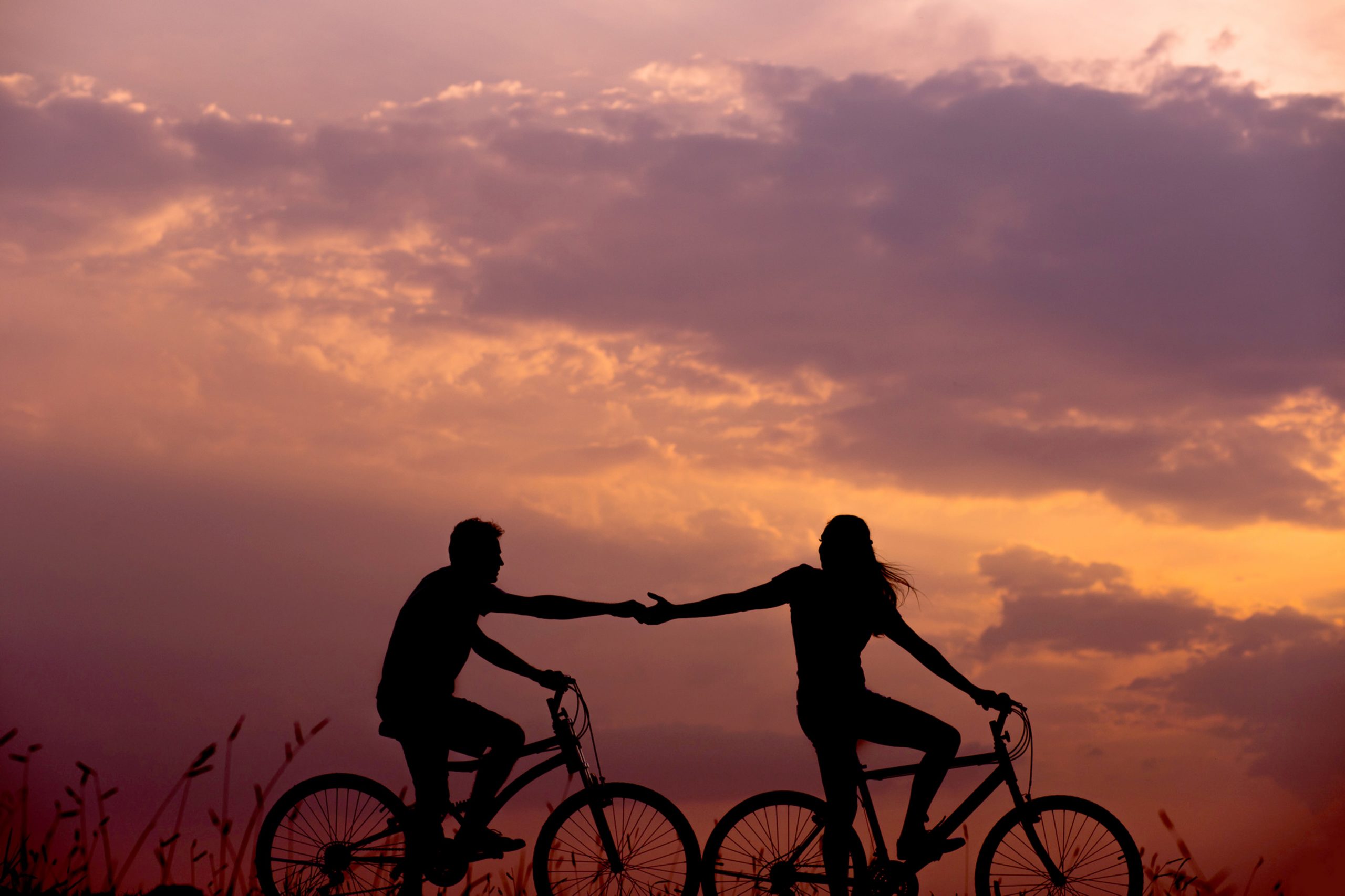 couple biking at sunset