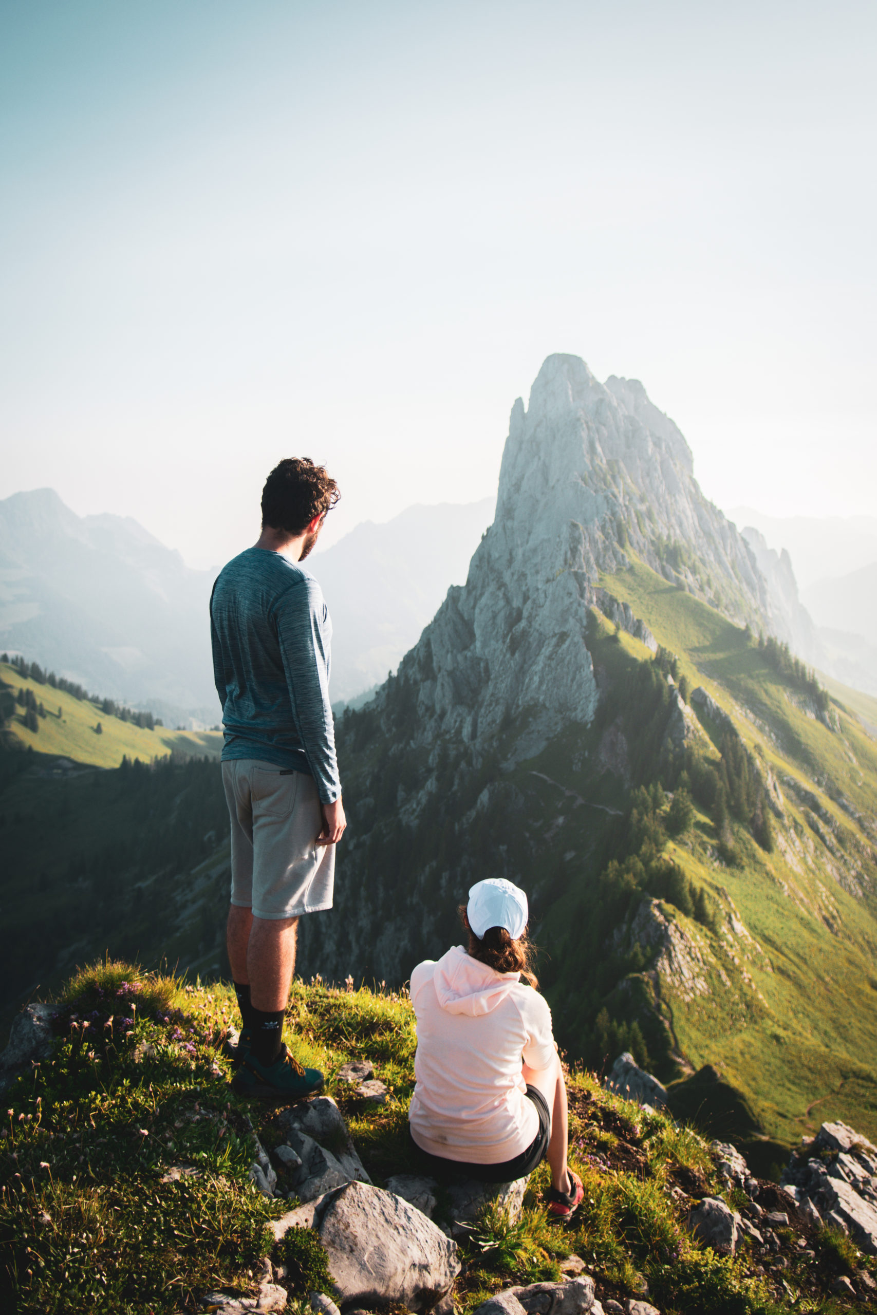 a couple standing in front of a mountain in Gastlosen in Switzerland
